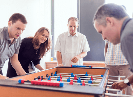 ADP employees play table football